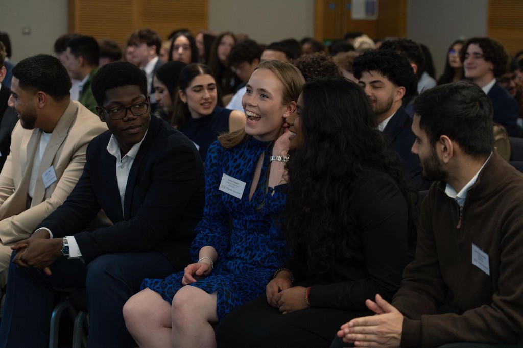 Community at an Investate event—diverse young professionals laughing and connecting